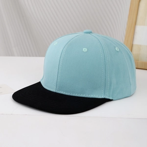 Detail of flat brim baseball cap with light blue crown and contrasting black visor
