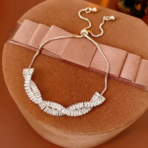 Luxurious silver twisted bracelet with rectangular zircons on brown velvet jewelry box