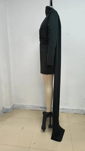 Detail of black striped blazer dress with long sleeves and floor-length side drape