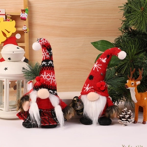 Pair of festive Christmas gnomes with knitted snowflake hats and cozy holiday decor