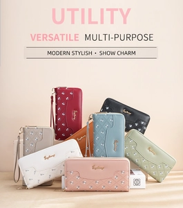 Detail of colorful long wallets showing floral patterns, stitching and wrist straps