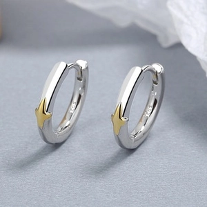 Macro view of 925 sterling silver hoop earrings with gold star and S925 engraving