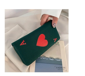 Detailed close-up of dark green canvas long wallet featuring a red Ace of Hearts design