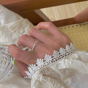 Minimalist 925 silver adjustable chain ring with sparkling zircons worn on model finger
