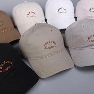 Close-up of cotton baseball caps showing COMFORT ZONES embroidery in various colors