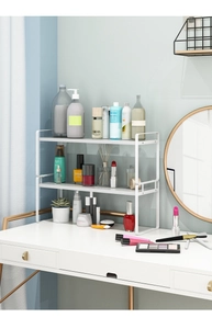 Close-up of white 2-tier metal kitchen organizer shelf on a minimalist countertop