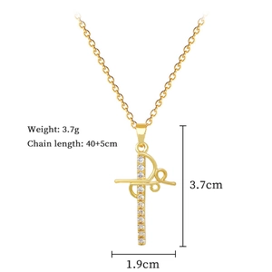 Detail view of gold cross pendant with crystal inlay and precise product dimensions