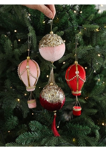 Detail of pink velvet hot air balloon Christmas ornament with gold glitter and sequins