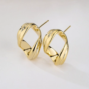Irregular geometric hollow oval earrings in 18K gold plated copper on white background
