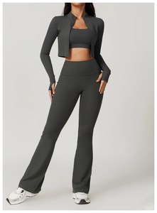 Detail of high-waist flared yoga pants and zip jacket in dark grey matte fabric
