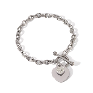 Macro shot of silver OT toggle clasp and dual heart pendants on a stainless steel bracelet
