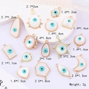 Golden Evil Eye charm collection in various shapes with white resin inserts for DIY jewelry