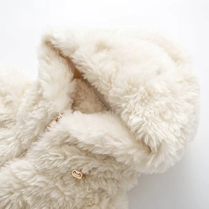 Detail of soft ivory faux fur hood with premium heart-shaped golden metal zipper pull