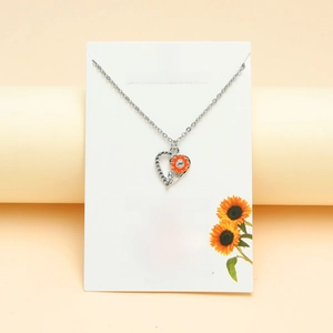 Silver sunflower heart necklace with orange enamel and crystals on English card