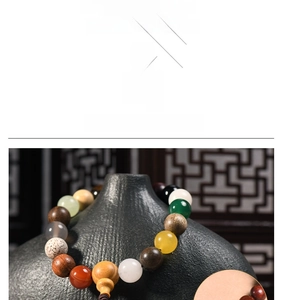 Detailed macro view of multi-color Bodhi seed beads and stones on a ceramic vase