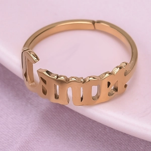 Detail of gold-plated open ring featuring a hollow Lucky letter design and polished finish