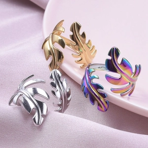 Macro detail of leaf-shaped rings in gold, silver and rainbow finish with open band