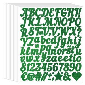 Macro detail of glitter green alphabet stickers with sparkling sand texture and cursive font