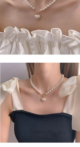 Detailed view of luxury pearl heart necklace with golden T-bar clasp and pink pendant