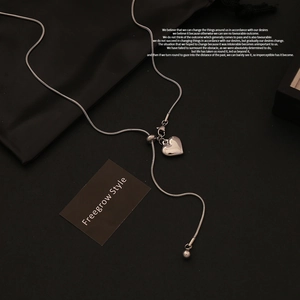 Detail of silver heart pendant with snake chain and adjustable sliding bead clasp