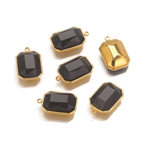 Detail of six rectangular black faceted gemstone pendants with golden metal edges