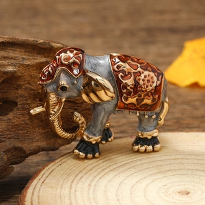 Macro shot of luxury elephant brooch with gold plating, brown enamel and crystals