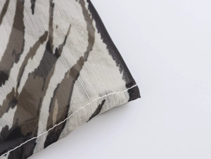 Close-up of zebra print chiffon fabric showing fine texture and clean stitched edges