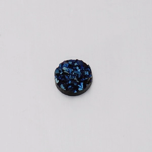 Close-up of 6mm dark blue resin crystal druzy cabochon with textured mineral surface