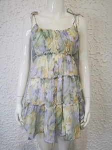 Close-up detail of tiered ruffle floral sundress in purple green and yellow print