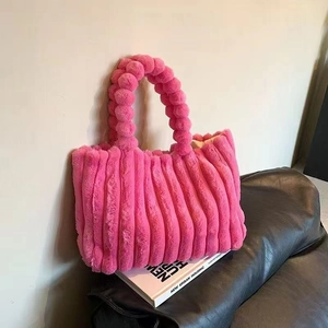 Pink plush tote bag with striped texture and decorative pom-pom handle for autumn winter
