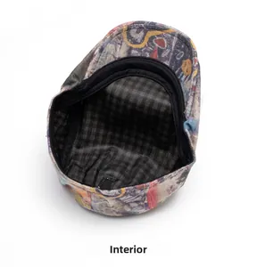 Detail view of American tie-dye flat cap featuring colorful graffiti and plaid inner lining