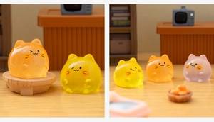 Close-up of colorful luminous cat figurines in orange and pink for fish tank decor
