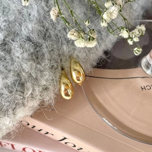 Elegant 925 sterling silver gold teardrop earrings on minimalist aesthetic background