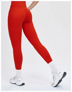Close-up of high-waist yoga pants in vibrant red showing butt-lifting fit and sleek fabric