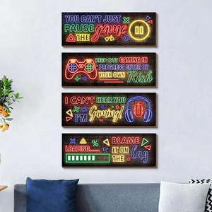 Detailed view of four vertical neon gaming wooden plaques with controller icons on a gray wall