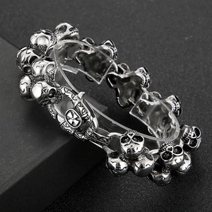 Close-up of vintage steel skull bracelet in antique silver with punk style cross clasp
