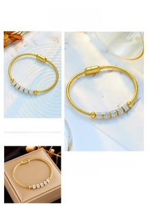 Detailed close-up of gold snake chain bracelet with micro-pave crystal beads and magnetic clasp