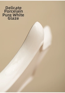 Close-up of a white ceramic tray with smooth glazed finish and delicate porcelain edge