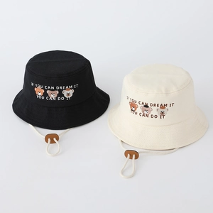 Detail of embroidered bears and adjustable chin straps on black and beige sun hats