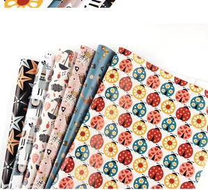 Close-up of colorful cartoon animal wrapping paper with ladybug and fox patterns