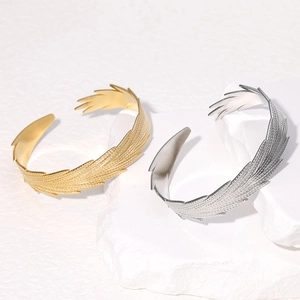 Minimalist stainless steel open feather bracelet in gold and silver finish with textures
