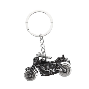 Realistic silver and black metal motorcycle engine keychain with detailed shock absorber