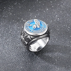 Macro shot of silver stainless steel ring featuring blue enamel and eagle insignia