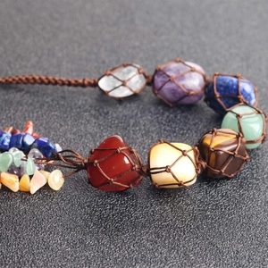 Macro shot of 7 chakra natural stones in a brown hand-woven mesh wall hanging