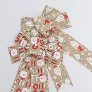 Close-up of faux burlap Christmas bow with Santa gnome and HO HO HO print details