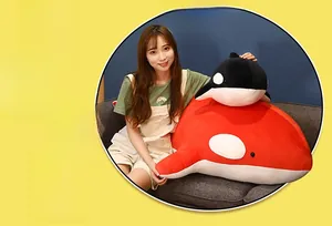 Detail of red and black orca plush toys with soft fabric and round stuffed shapes