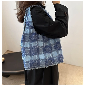 Sac cabas en jean à damier bleu avec bords effilochés porté par un mannequin vue de l'arrière