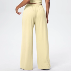 Rear view of pale yellow high-waisted wide-leg lounge pants with elastic waistband