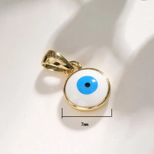 Macro shot of 7mm Evil Eye pendant charm with gold plating and blue enamel inlay