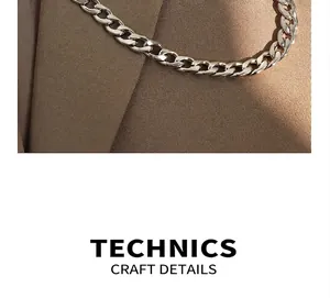 Macro close-up showing polished silver flat Cuban link chain on textured fabric background